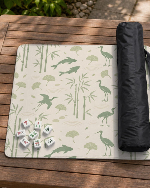 Cream mahjong mat with sage green koi, crane, ginkgo, and bamboo artwork in a repeating decorative layout.