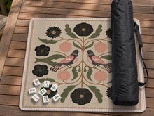 Square mahjong mat with a blush background, vintage flowers, olive leaves, and two mirrored folk-style birds.