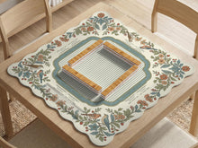 Scalloped square mahjong mat with bird illustrations, cream flowers, sage leaves, and a striped center with printed rules text.