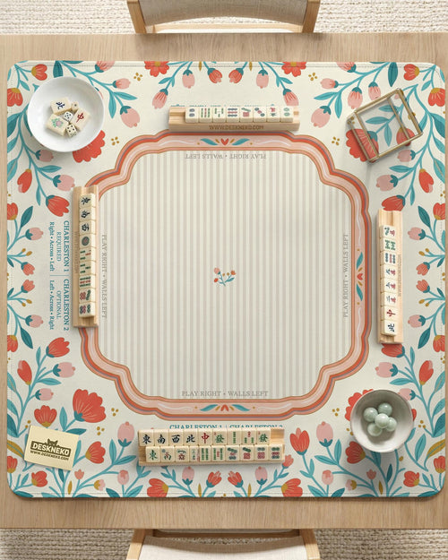 Cream mahjong mat with a coral and teal floral border, rule layout text, Charleston guide notes, and a blank center area for tile play.