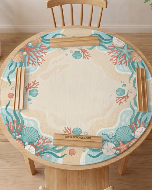 Aqua mahjong mat with seashell and coral artwork, pearl details, and a soft beach color palette in turquoise, cream, and sandy tones.