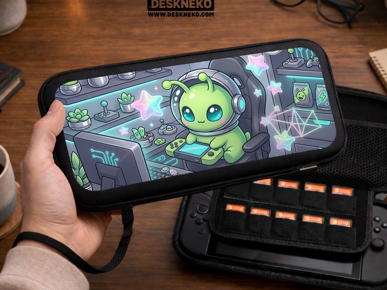 A Switch carrying case design with a cute green alien at a gaming desk, glowing cyan lights, and pastel stars on a dark background.