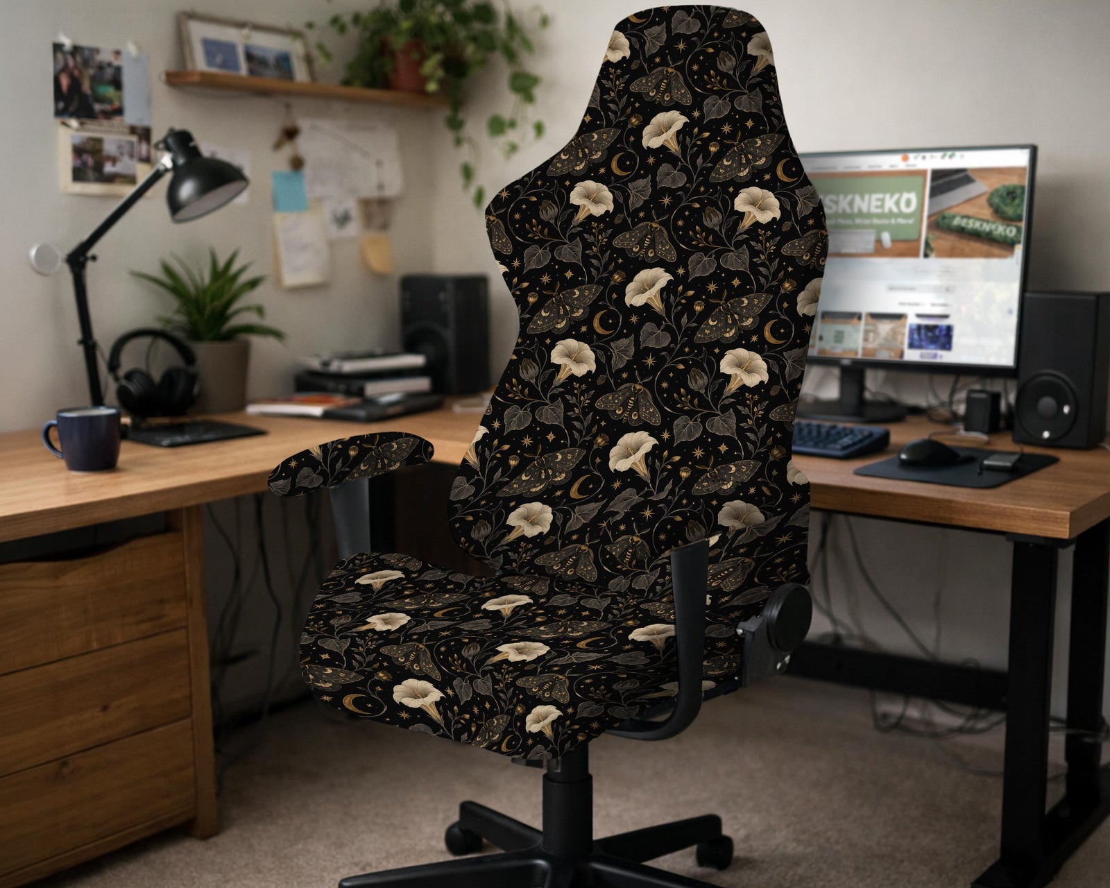 Black chair cover with a dark floral pattern featuring cream flowers, gold moths, small moon accents, and shadowy leaves.