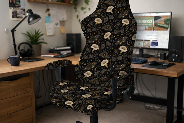 Black chair cover with a dark floral pattern featuring cream flowers, gold moths, small moon accents, and shadowy leaves.