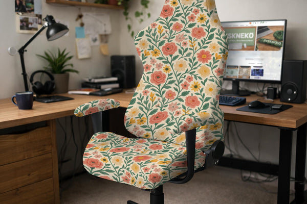 Cream chair cover with coral flowers, yellow blooms, and green leafy vines covering a gaming or office chair.
