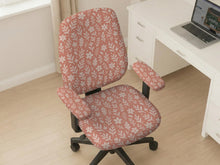 Pink chair cover with a botanical floral print shown on an office chair, with matching armrest covers and multiple cover style options.