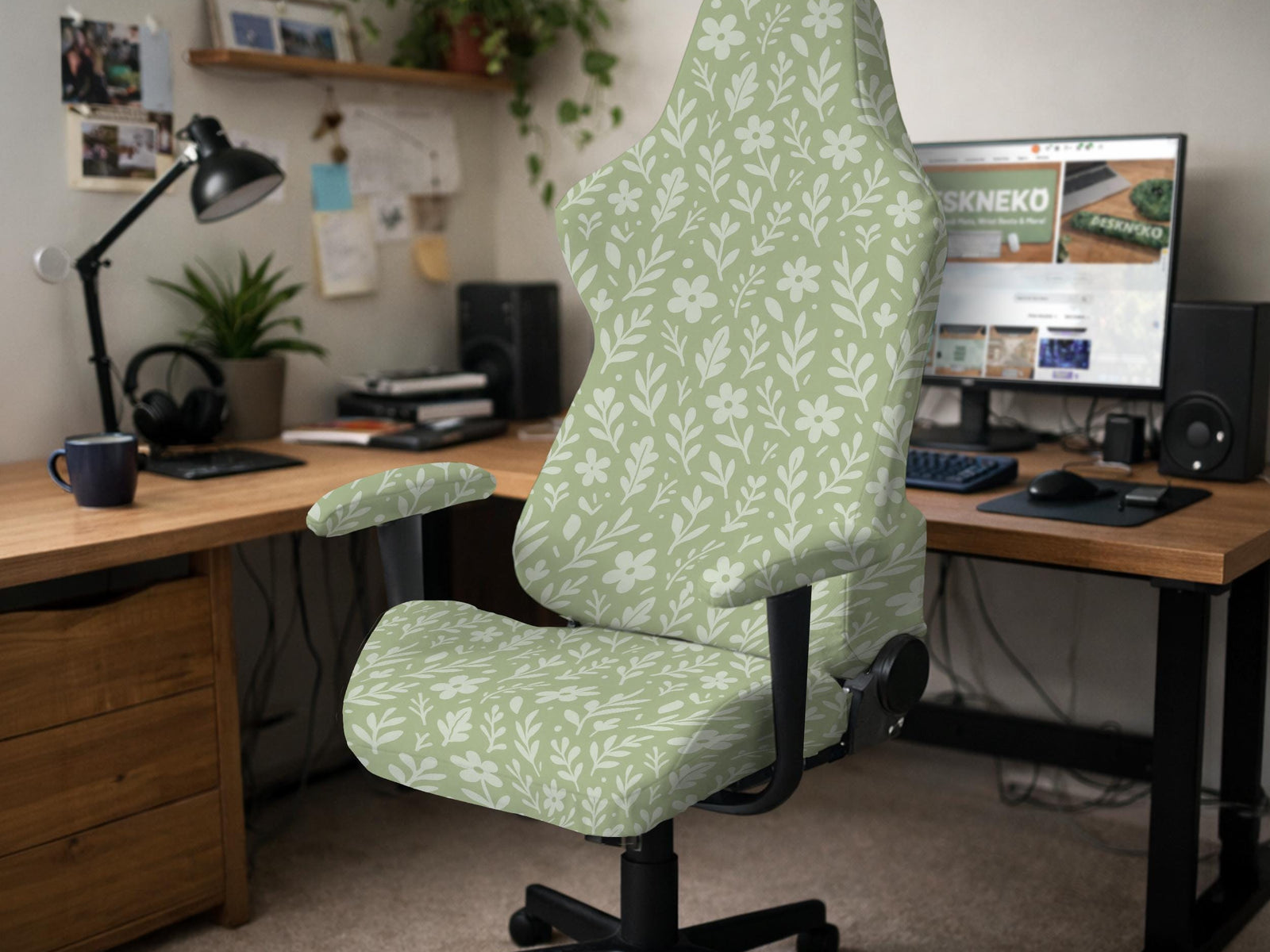 Green chair cover with a small botanical floral print in sage and cream.