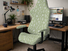 Green chair cover with a small botanical floral print in sage and cream.