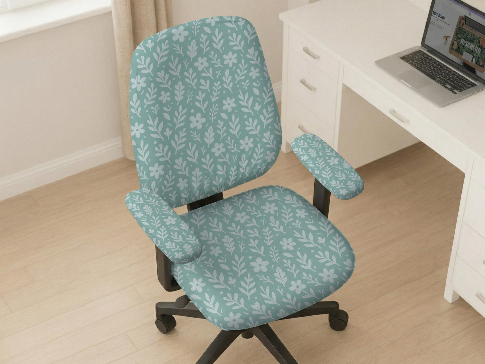 Mint and white botanical desk chair cover with a floral leaf pattern shown on an office chair.