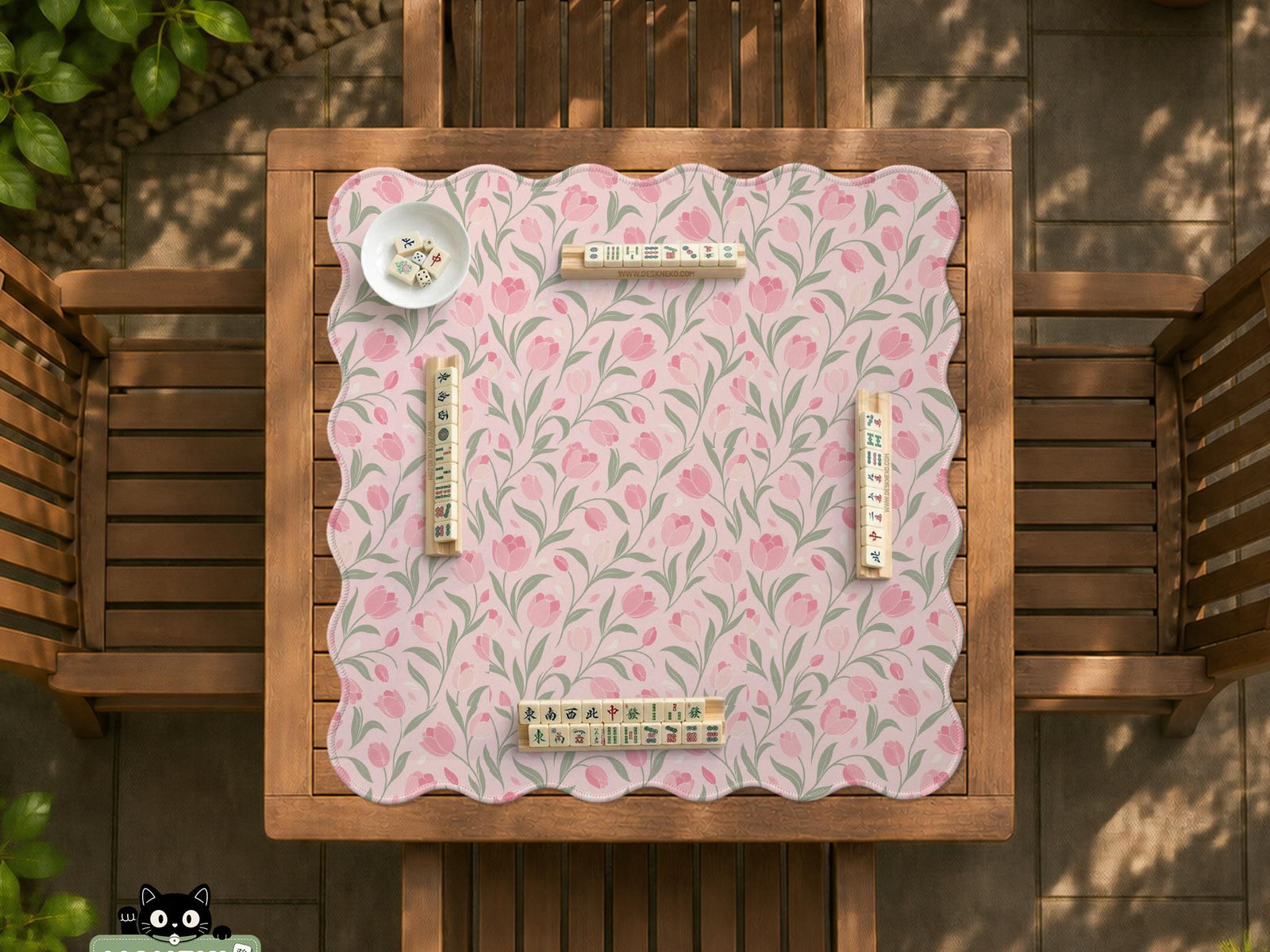 Pink mahjong mat with a tulip floral pattern in blush and sage tones and a scalloped edge.