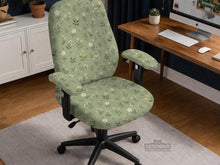 Sage green chair cover with a small floral print shown on a desk chair with a high back.
