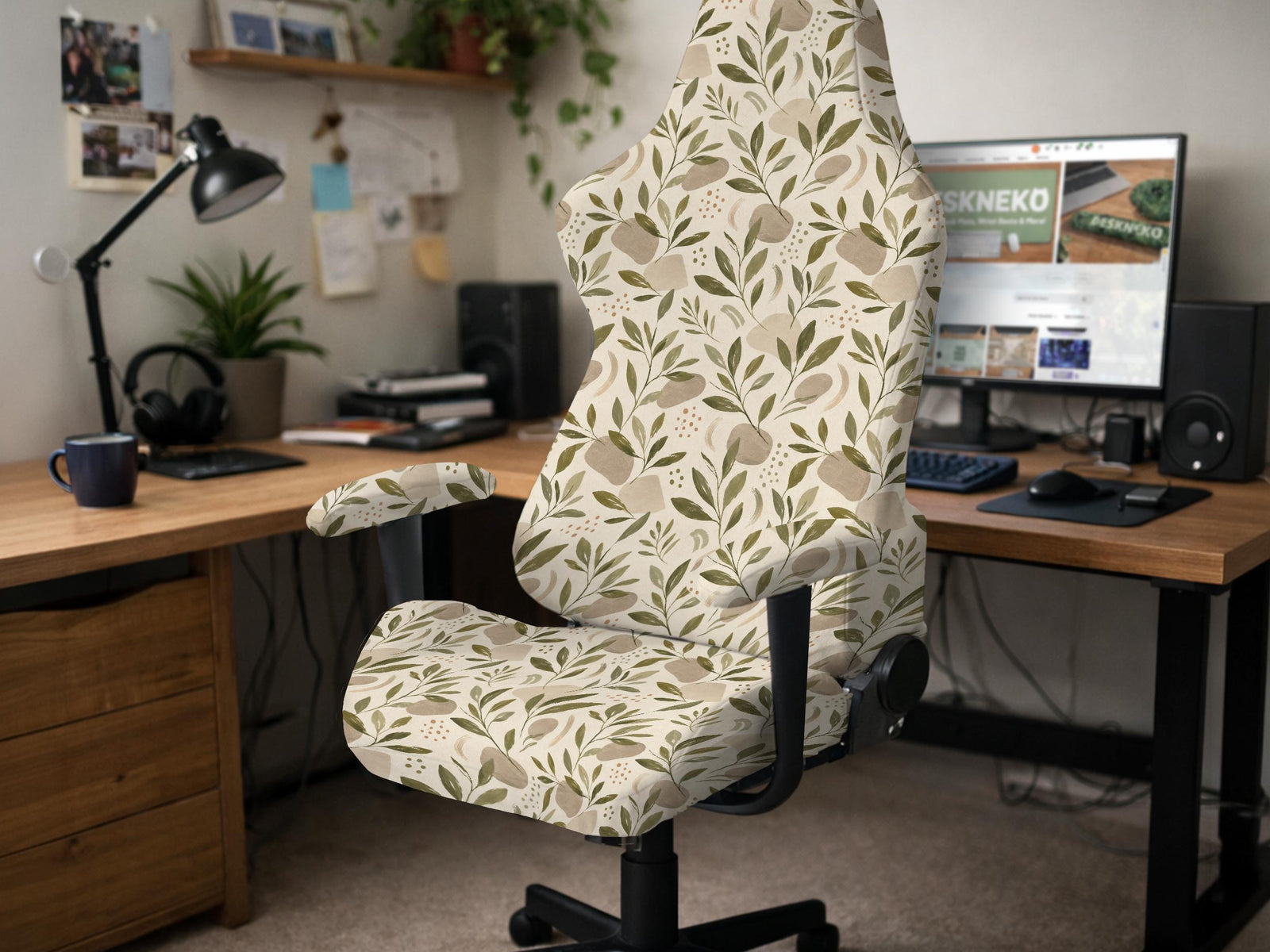 A neutral botanical print chair cover shown on a high back gaming-style office chair with armrests.