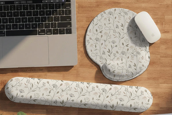 Ivory mouse pad and keyboard wrist rest with delicate wildflower line art in sage, taupe, and cream tones.
