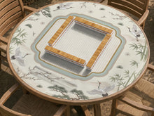 Square ivory mahjong mat with crane and bamboo pattern, a striped center, light blue border, and thin gold trim.