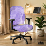 Office chair fitted with a stretch cover in a soft lavender marble swirl print with gold flecks, shown in a home office