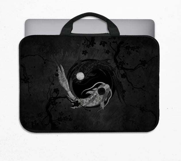 Padded laptop sleeve with carry handles printed with a dark yin-yang koi design of silver and black koi fish circling a moon among ink plum branches, holding a laptop