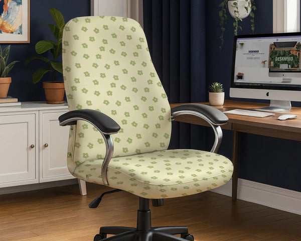 Office chair fitted with a stretch cover in a cream print scattered with small sage-green daisies, shown in a home office
