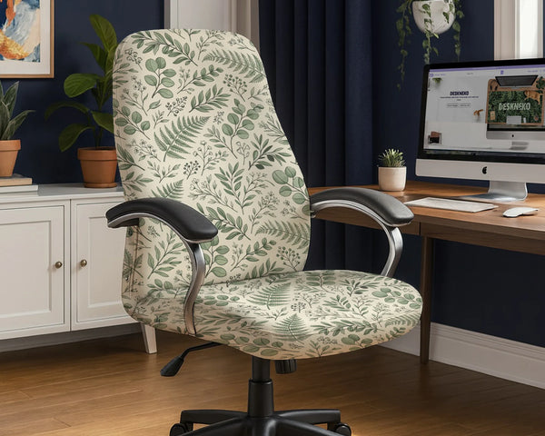 Office chair fitted with a stretch cover in a cream and sage-green fern and eucalyptus leaf print, shown in a home office
