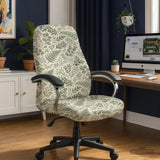 Office chair fitted with a stretch cover in a cream and sage-green fern and eucalyptus leaf print, shown in a home office