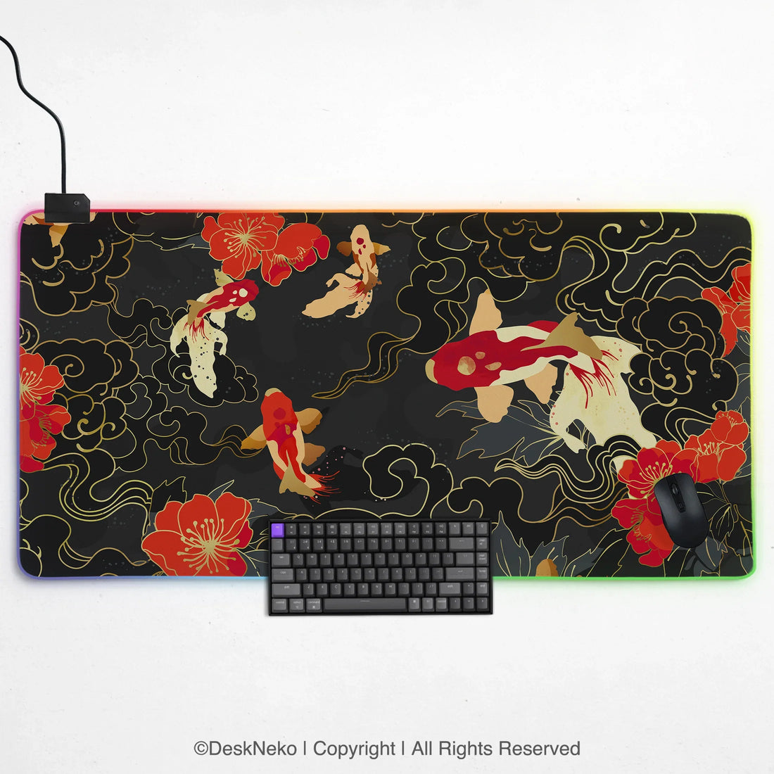 Koi fish RGB gaming desk mat with red, white and gold koi and red blossoms on a black and gold cloud print, framed by a glowing rainbow LED edge, shown with a keyboard and mouse