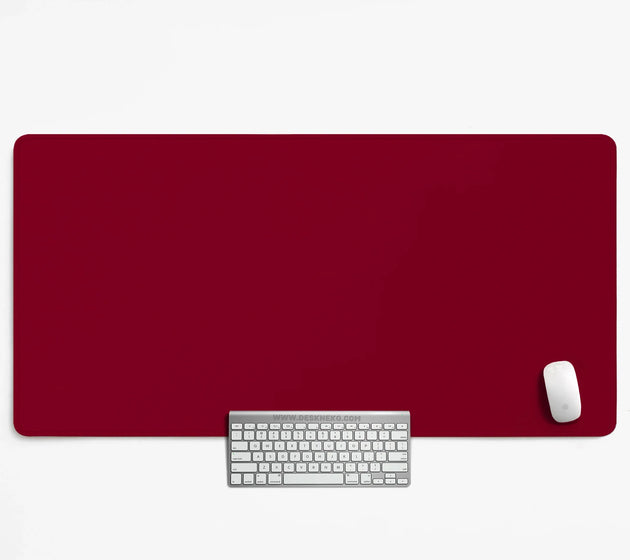 Solid deep burgundy desk mat in a plain color, shown with a keyboard and white mouse