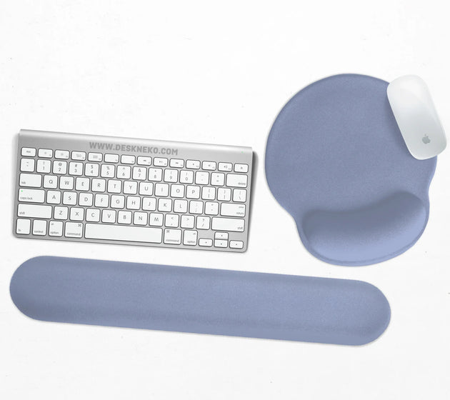 Soft periwinkle-blue ergonomic set with a round gel mouse pad and a keyboard wrist rest in a plain color, shown with a keyboard and mouse