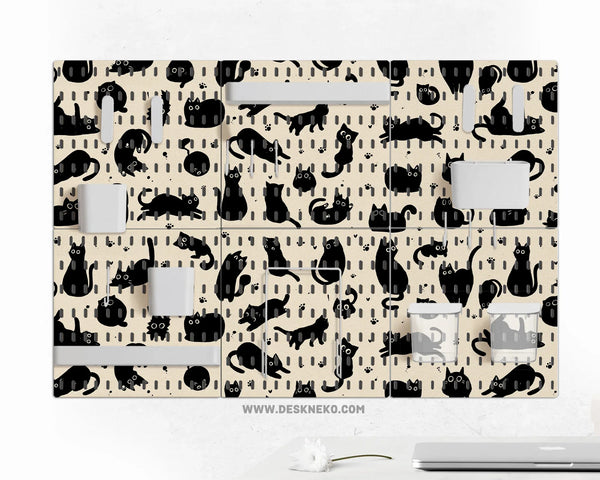 Pegboard wall organizer set printed with playful black cat silhouettes and paw prints on a cream background, fitted with white shelves, cups and hooks