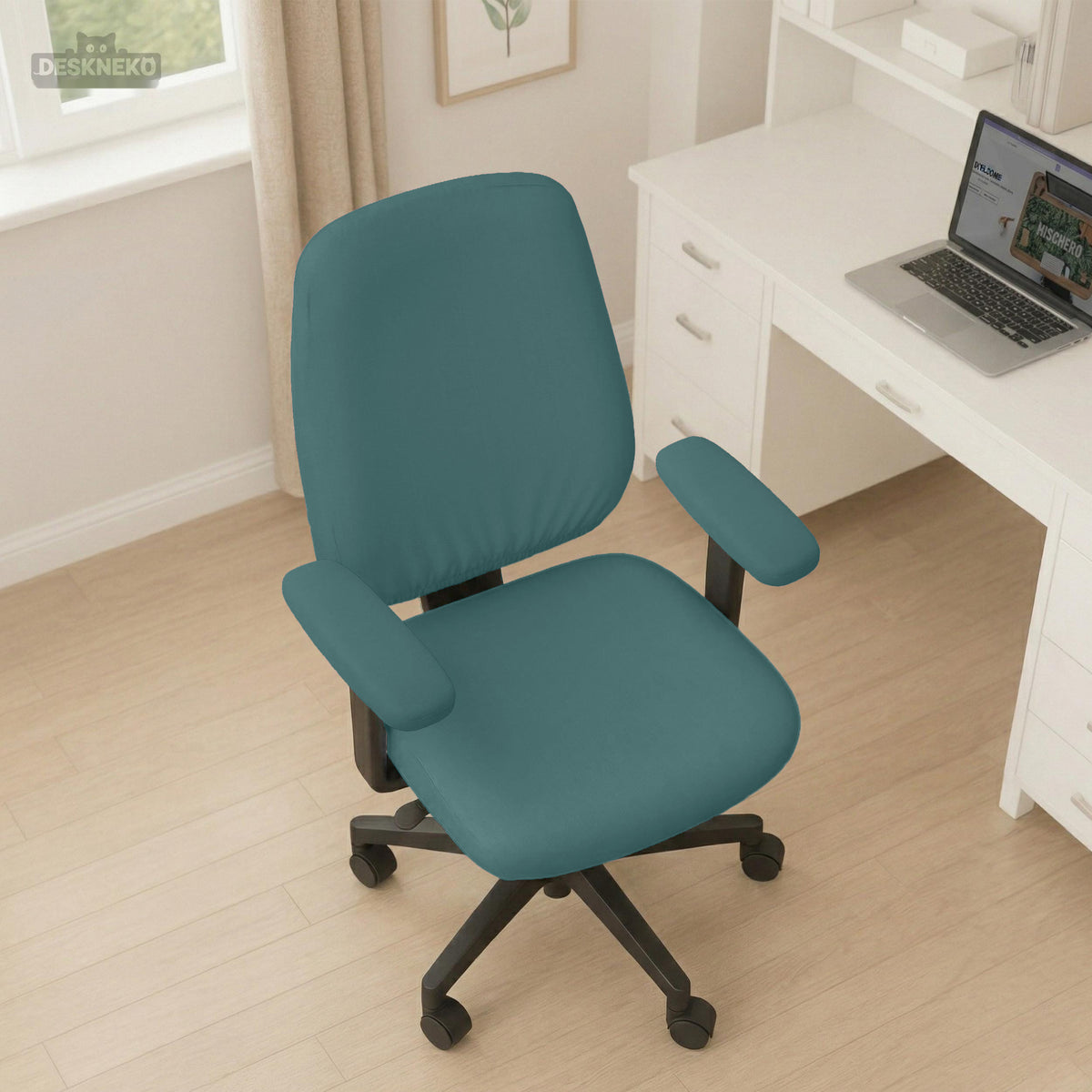 Teal stretch chair covers on an office chair beside a desk. Selected cover option only; chair and accessories not included.