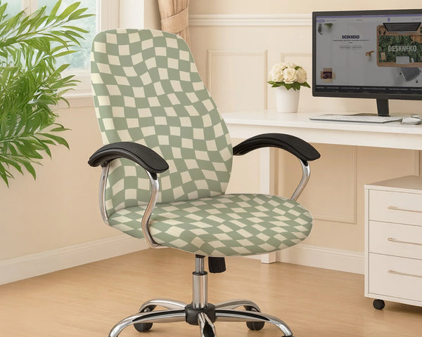 Office chair fitted with a stretch cover in a wavy sage-green and cream checkerboard print, shown in a home office