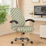 Office chair fitted with a stretch cover in a wavy sage-green and cream checkerboard print, shown in a home office