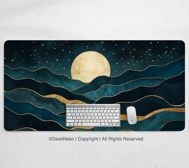 Moonrise desk mat printed with a large gold moon over layered teal and gold mountain waves and a gold-flecked starry sky, shown with a keyboard and mouse