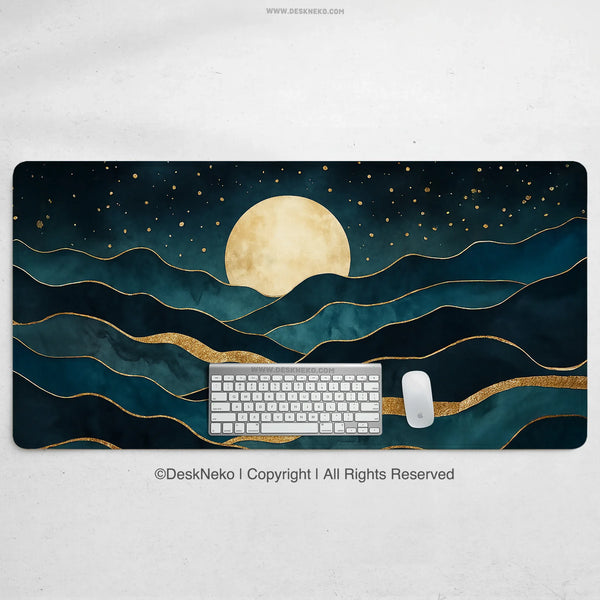 Moonrise desk mat printed with a large gold moon over layered teal and gold mountain waves and a gold-flecked starry sky, shown with a keyboard and mouse