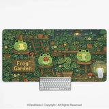 Frog garden desk mat illustrated with cute frogs in a cozy plant-filled greenhouse beside a wooden 'Frog Garden' sign, shown with a keyboard and mouse