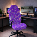 Gaming chair fitted with a stretch cover in a purple 1980s Memphis-style geometric print with cubes, circles and zigzags, shown in a gaming setup