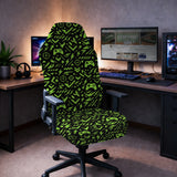Gaming chair fitted with a black stretch cover printed with neon green game controllers, crosshairs and lightning bolts, shown in a gaming setup