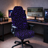 Gaming chair fitted with a black stretch cover printed with purple game controllers, crosshairs and lightning bolts, shown in a gaming setup