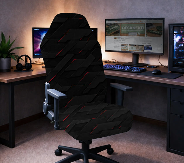 Gaming chair fitted with a black stretch cover in a 3D tech geometric pattern with red accent lines, shown in a gaming setup