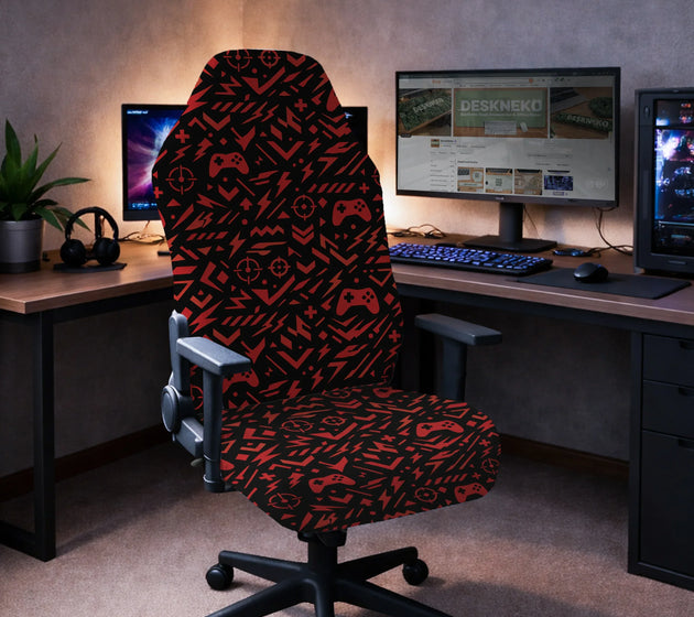 Gaming chair fitted with a black stretch cover printed with red game controllers, crosshairs and lightning bolts, shown in a gaming setup