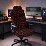 Gaming chair fitted with a black stretch cover printed with red game controllers, crosshairs and lightning bolts, shown in a gaming setup