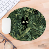 Cats in the Bushes mousepad on a wooden desk