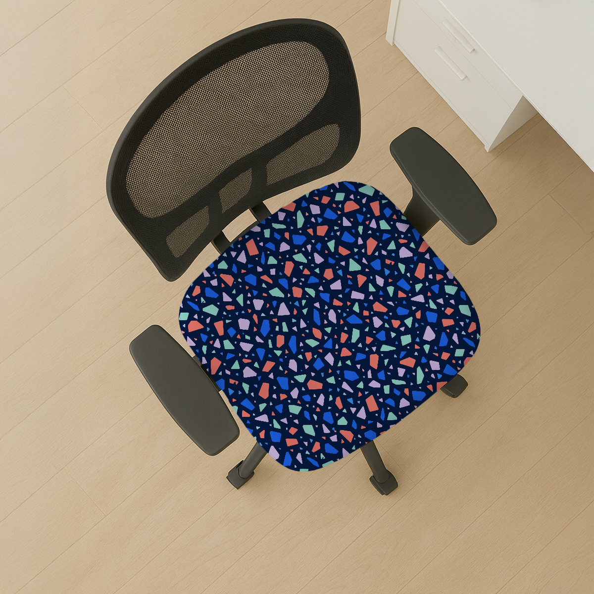 Electric Terrazzo seat-only cover on a mesh-back chair; mesh back and armrests stay bare.