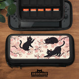 Switch case with black cats and cherry blossoms on a light pastel background.