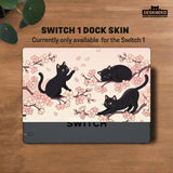 Switch case with black cats and cherry blossoms on a light pastel background.