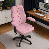Pink chair cover with a pattern of moons, stars, bows, and small decorative shapes on a chair with armrests.