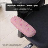 Pink chair cover with a pattern of moons, stars, bows, and small decorative shapes on a chair with armrests.