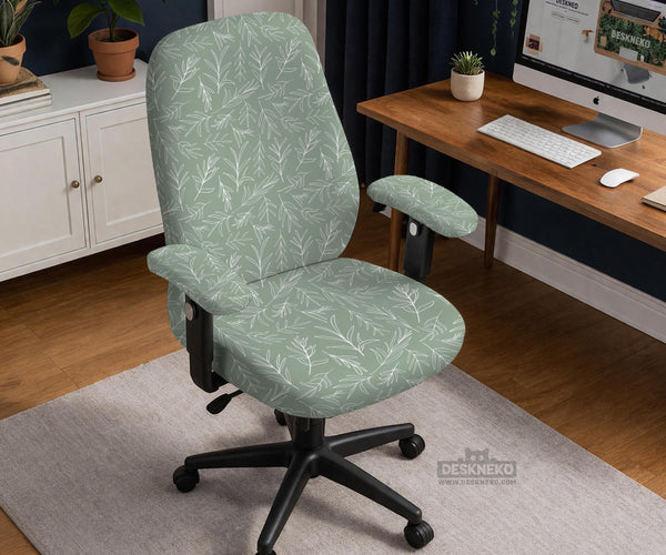 Office chair cover in muted sage green with a light leaf pattern on a white background.