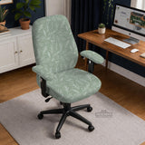 Office chair cover in muted sage green with a light leaf pattern on a white background.