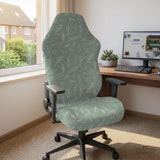 Office chair cover in muted sage green with a light leaf pattern on a white background.