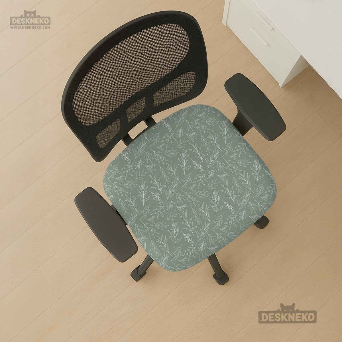 Office chair cover in muted sage green with a light leaf pattern on a white background.