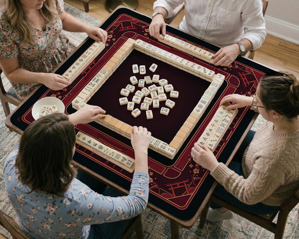 Square burgundy mahjong mat with a cherry blossom floral border and a dark open center.